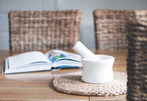 Pestle and mortar beside book